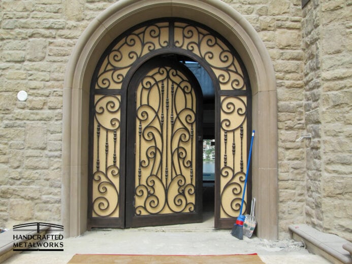 Ornate double front arched custom doors.